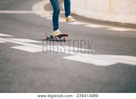 One Young Skateboarder Legs Sakteboarding On Highway