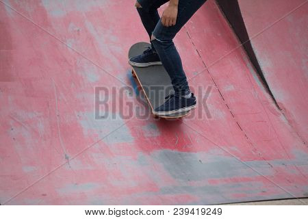 One Young Skateboarder Sakteboarding On Skatepark Ramp