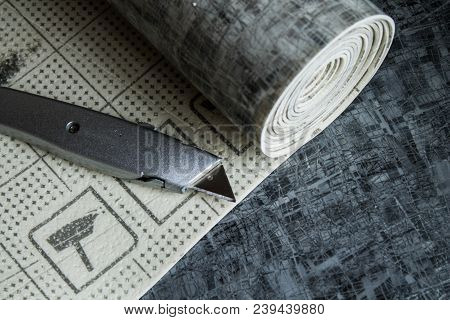 Gray Linoleum Rolled Up, Cut Into Pieces