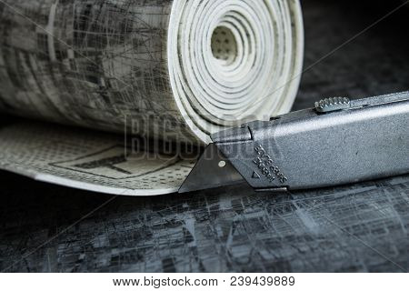 Gray Linoleum Rolled Up, Cut Into Pieces