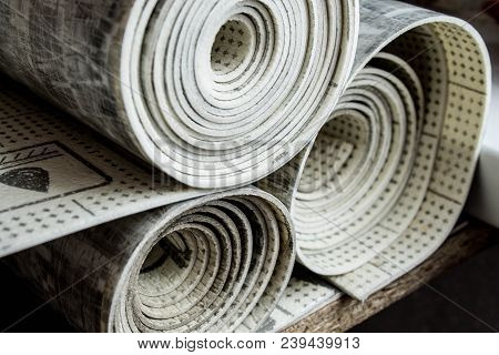 Gray Linoleum Rolled Up, Cut Into Pieces