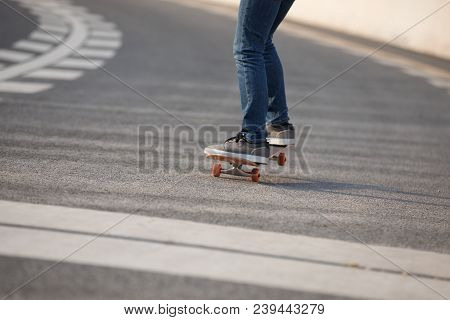 Closeup Of Skateboarder Sakteboarding On City Highway