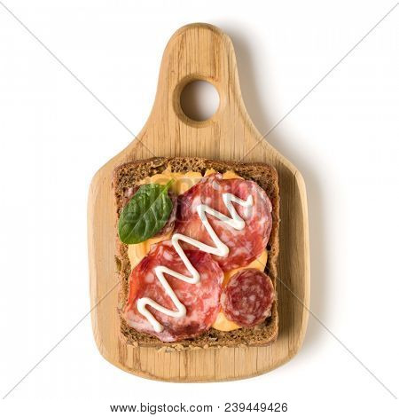 Open  faced sausage sandwich canape or crostini on a wooden serving board  isolated on white background closeup. Top view.
