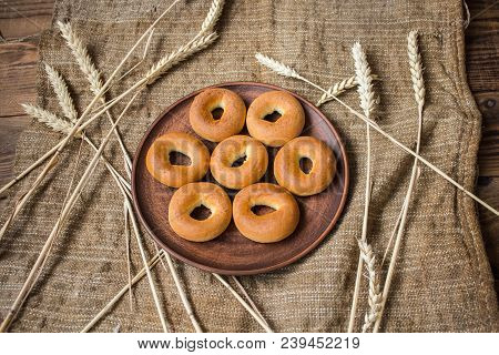 Bagels In A Plate With Spikelets On Sackcloth Background
