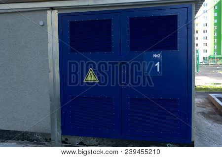 Red Garage Gate With Ventilation Grilles. Large Automatic Up And Over Garage Door With Inclusion Of 