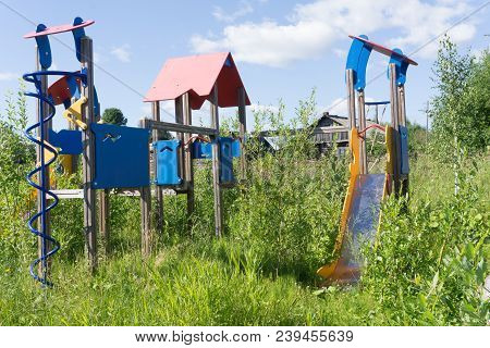 Old Neglected Playground Equipment, Overgrown With Weeds