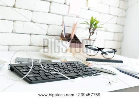 Close Up Gedgets On Workplace White Desk With Laptop And Smartphone