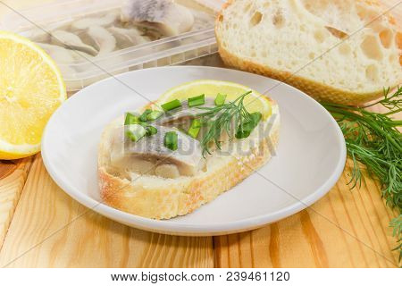 Open Sandwich With Slices Of Pickled Herring Fillet On A Saucer Among Of Ingredients For Its Prepara
