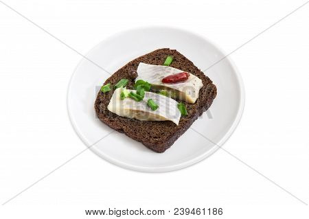 Open Sandwich Made Of Brown Bread, Slices Of Fillet Of Pickled Atlantic Herring, Hot Pepper And Gree