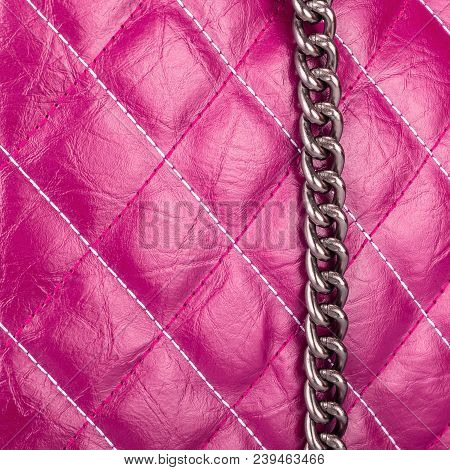 Purple Leather Textured Material Sewn With Threads In The Form Of Rhombus With A Hanging Metal Chain