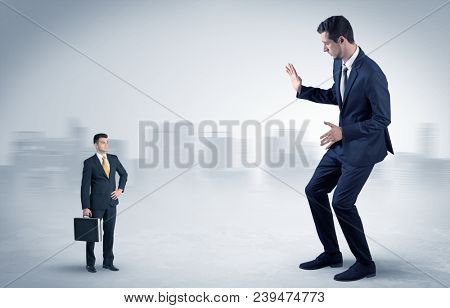 Giant businessman being afraid of small serious executor with suitcase
