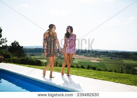 Beautiful Appy Girls Smiling By The Pool And Enjoying Summer