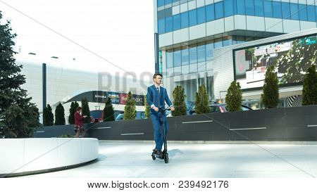 Using Electric Scooter On The Street