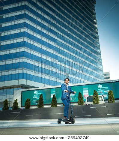 Using Electric Scooter On The Street