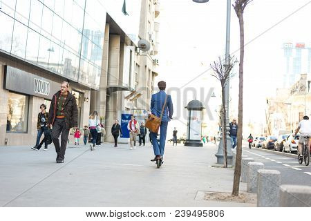 Using Electric Scooter On The Street