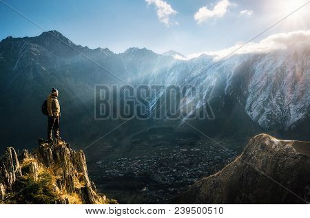 Backpacker Sit On Cliff Edge And Looks At Mount Valley