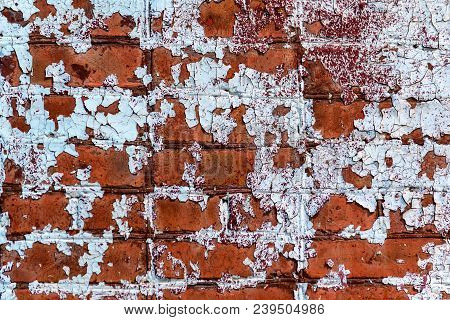 Close Up Obsolete Red Brick Wall With Weathered Cracked White Paint