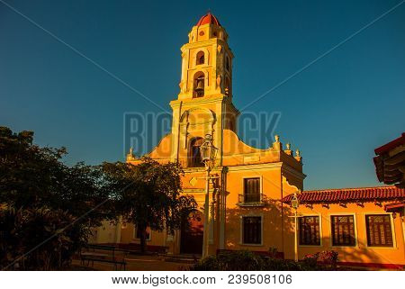 Trinidad, Cuba. The Bell Tower Of San Francisco De Asis Against The Blue Sky. Street In The Center O