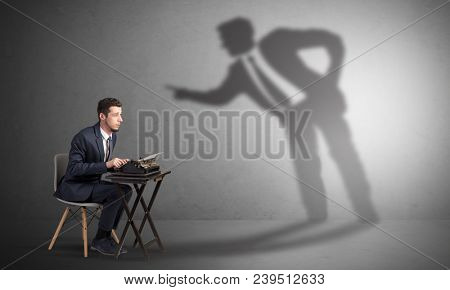 Little man working and a big shadow arguing with him