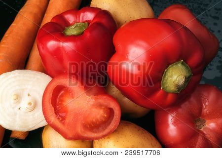 Red Sweet Pepper, Tomatoes, Carrots And Potato Tubers On A Black Background