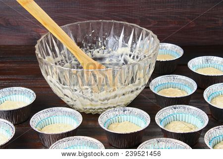 Dough In Molds For Muffins On A Wooden Table