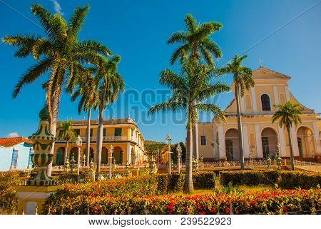 Trinidad, Cuba, Plaza Mayor And Church Of The Holy Trinity, Bench And Statue In Foreground.