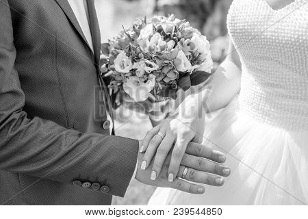 Hands And Rings Of The Bride And Groom On A Wedding Buke Black And White Photo