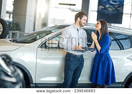Beautiful Housewife With Expressive Face Asking Her Husband To Buy Her A New Car In Showroom
