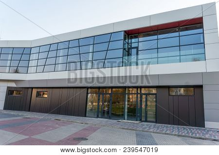 Details Of Aluminum Facade With Colorful Red And Orange Panels On Large Shopping Mall.