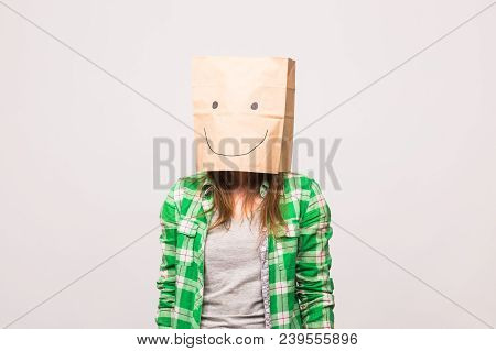 Happy Unknown Woman With A Paper Bag On Her Head On White Background.