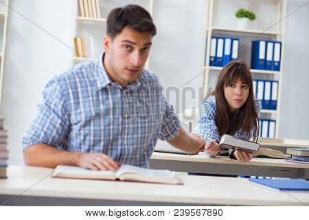 Students sitting and studying in classroom college