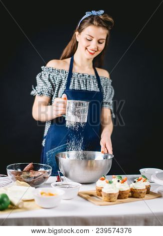 Hapy Caucasian Female Cook Chef Sifts Flour, Preparing The Dough. Concept: Dessers Bakery Art