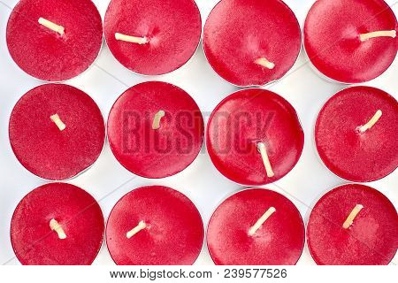 Scented Tea Light Candles On A White Background. Close Up Collection Of Red Candles In Metal Base.
