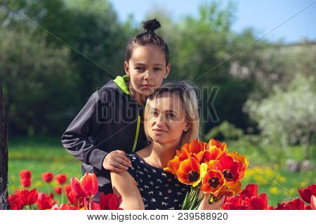 Happy Family In The Red And Yellow Tulips Field