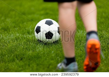 Football Or Soccer Ball At The Kickoff Of A Game. Soccer Free Kick At A Grass Pitch. Young Soccer Pl