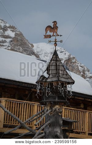 Weathercock, Weather Vane Wind Direction Decoration On Roof With Fresh Snow.
