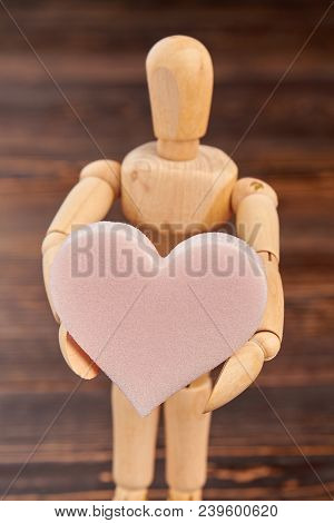 Wooden Dummy Holding Pink Soft Heart. Wooden Person Standing With Heart Shaped Sponge. Valentines Ho