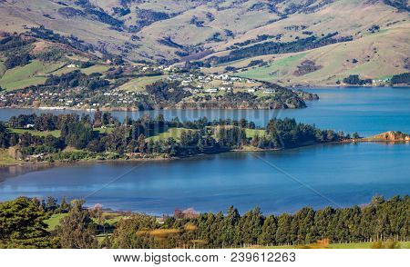 Landscape View Of The Rolling Hills And Harbour Of Akaroa, Banks Peninsular, New Zealand.