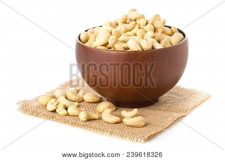 Heap Of Raw, Organic, Whole Cashew Nut Kernels In Wooden Bowl Over White Background