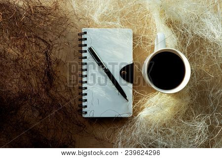 Spiral Notebook, Pen, Mug Of Coffee And Shredded Paper
