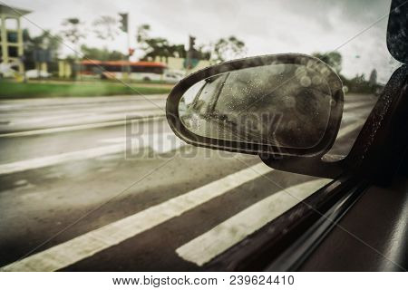 Wet Side Rear View Mirror On Cloudy Day From Moving Car