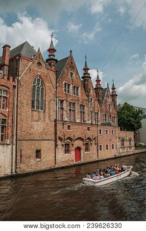 Bruges, Belgium - July 05, 2017. Boat And Brick Buildings On The Canal Edge At Bruges. With Many Can
