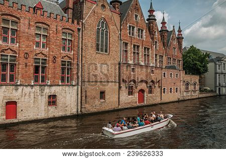 Bruges, Belgium - July 05, 2017. Touristic Boat And Brick Buildings On The Canal Edge At Bruges. Wit