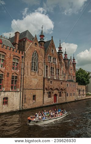 Bruges, Belgium - July 05, 2017. Boat And Brick Buildings On The Canal Edge At Bruges. With Many Can