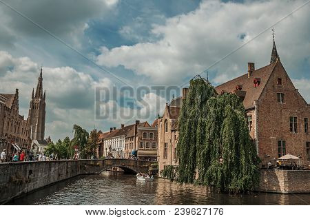 Bruges, Belgium - July 05, 2017. People And Old Buildings On The Canal Edge At Bruges. With Many Can