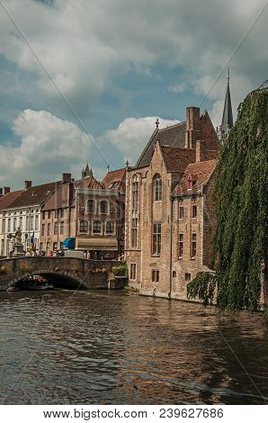 Bruges, Belgium - July 05, 2017. Bridge And Old Buildings On The Canal Edge At Bruges. With Many Can