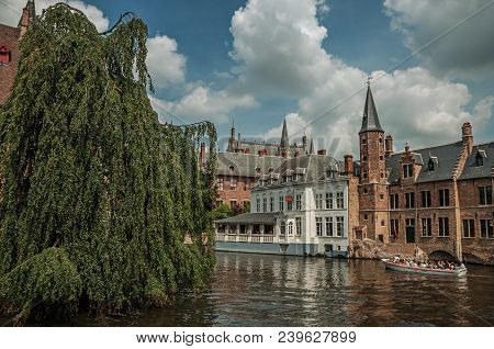 Bruges, Belgium - July 05, 2017. Boats And Old Buildings On The Canal Edge At Bruges. With Many Cana