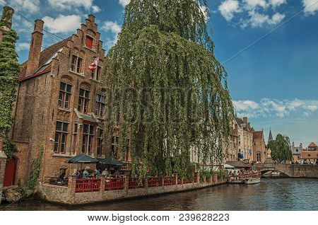 Bruges, Belgium - July 05, 2017. Boats And Old Buildings On The Canal Edge At Bruges. With Many Cana