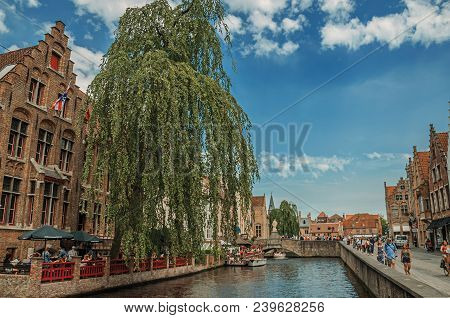 Bruges, Belgium - July 05, 2017. Boats And Old Buildings On The Canal Edge At Bruges. With Many Cana