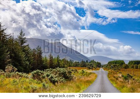 Straight one lane country road with Passing Places going through scenic scottish landscape at Isle of Mull, Inner Hebrides, Scotland, UK